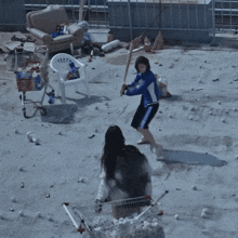 a woman in a blue jacket is throwing a baseball in the air