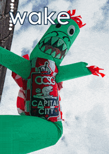 an inflatable green monster with capital city on it