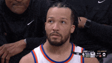 a basketball player with the number 12 on his jersey looks up at the sky