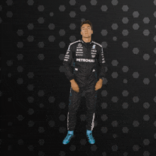 a man in a petronas racing suit is dancing
