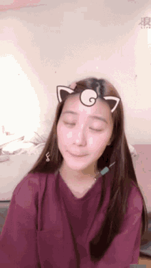 a woman wearing a cat ear sticker on her head