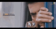 a close up of a man 's face with the words goodwill written on the bottom