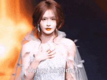 a woman in a white dress with the words happy birthday below her