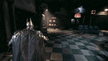 a man in a batman costume stands in a dark room with a sign that says " the joker " on it