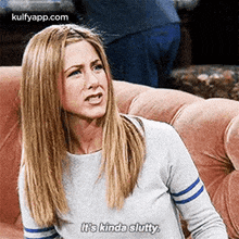 a woman is sitting on a couch and talking to someone .