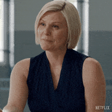 a woman is sitting in front of a netflix sign