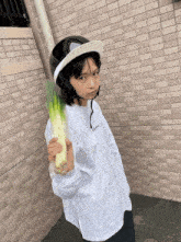 a person wearing a helmet and a shirt that says justice holds a vegetable