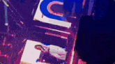 a woman is laying on a stage in front of a sign that says ' uc ' on it