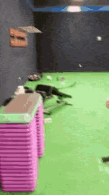 a green room with a stack of pink boxes