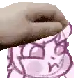 a close up of a person 's hand on top of a cartoon character .
