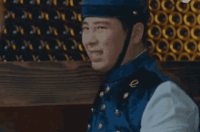 a man wearing a blue uniform with a gold e on the chest