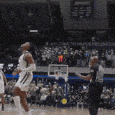 a basketball game is being played in front of a crowd with a sign that says welcome to hinkle fieldhouse