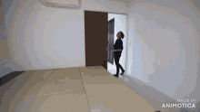a woman is standing in a room with the words made in animatica on the bottom of the screen