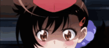 a close up of a girl with a red hat on her head