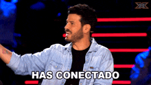 a man in a denim jacket says has conectado in spanish
