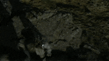 a person laying on their back on a rocky cliff