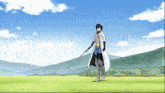 a man in a white coat is holding a sword in a field with mountains in the background