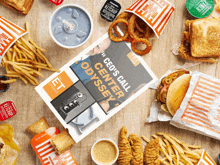 a book titled " ceo 's call center odyssey " is surrounded by various fast food items