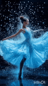 a woman in a blue dress is dancing in the water