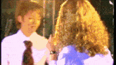 a woman and a boy are talking to each other