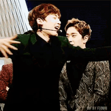 a gif of two men hugging with the words gif by fiuki on the bottom right