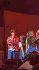 a group of people are dancing on a stage in a pixelated image