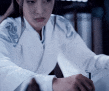 a woman in a white shirt with a dragon on her shoulder
