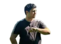 a man wearing a black adidas shirt checks his watch