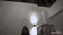a woman is standing in a dark room with the words made in animotica on the bottom right