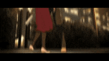 a blurry image of a woman in a red skirt