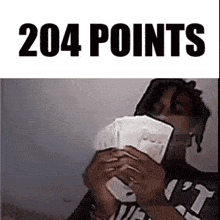 a man holding a pile of money with the words 204 points written above him