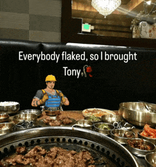 a sign that says everybody flaked so i brought tony sits above a table full of food