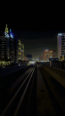 a train is going down the tracks in the dark