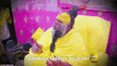 a man in a yellow robe is talking into a microphone with the words tumhara ladkiyo ke prati below him