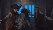 a group of people dressed in pirate costumes are posing for a photo