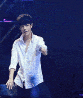 a man in a white shirt is dancing in front of a red background with the name pupi1005 on it