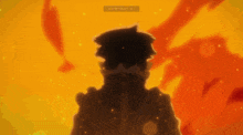 a silhouette of a person standing in front of a fire with the letters l and r visible