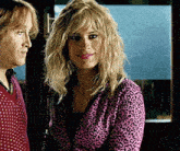 a woman in a pink leopard print jacket is standing next to a man