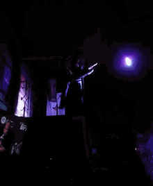 a man playing a keyboard in a dark room with a sign that says ufc