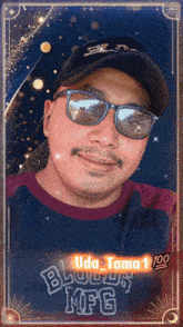 a man wearing sunglasses and a hat with the name uda tama on the bottom right