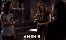 a man and a woman are standing next to each other in a room and the woman is saying amen !