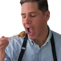 a man in a blue shirt and black suspenders is eating food with chopsticks