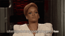 a woman in a white shirt is sitting in a chair and says ohmygodmygodmygod fuse .