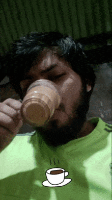 a man drinking a cup of coffee with a cup of coffee on a saucer