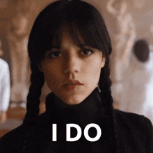 a woman with pigtails says i do in white letters
