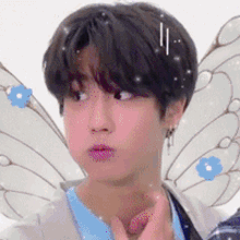 a close up of a person with wings on their heads