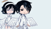a boy and a girl are standing next to each other with wings