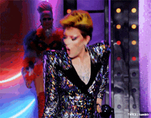 a woman in a sequined jacket is standing in front of a purple wall with the words t4yce tumblr written below her