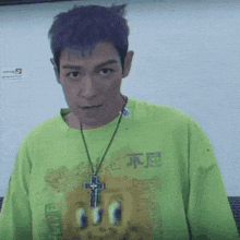 a man with purple hair is wearing a green shirt that says supreme on it