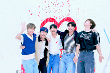 a group of young men are posing for a picture and one of them is wearing a shirt that says taikei on it